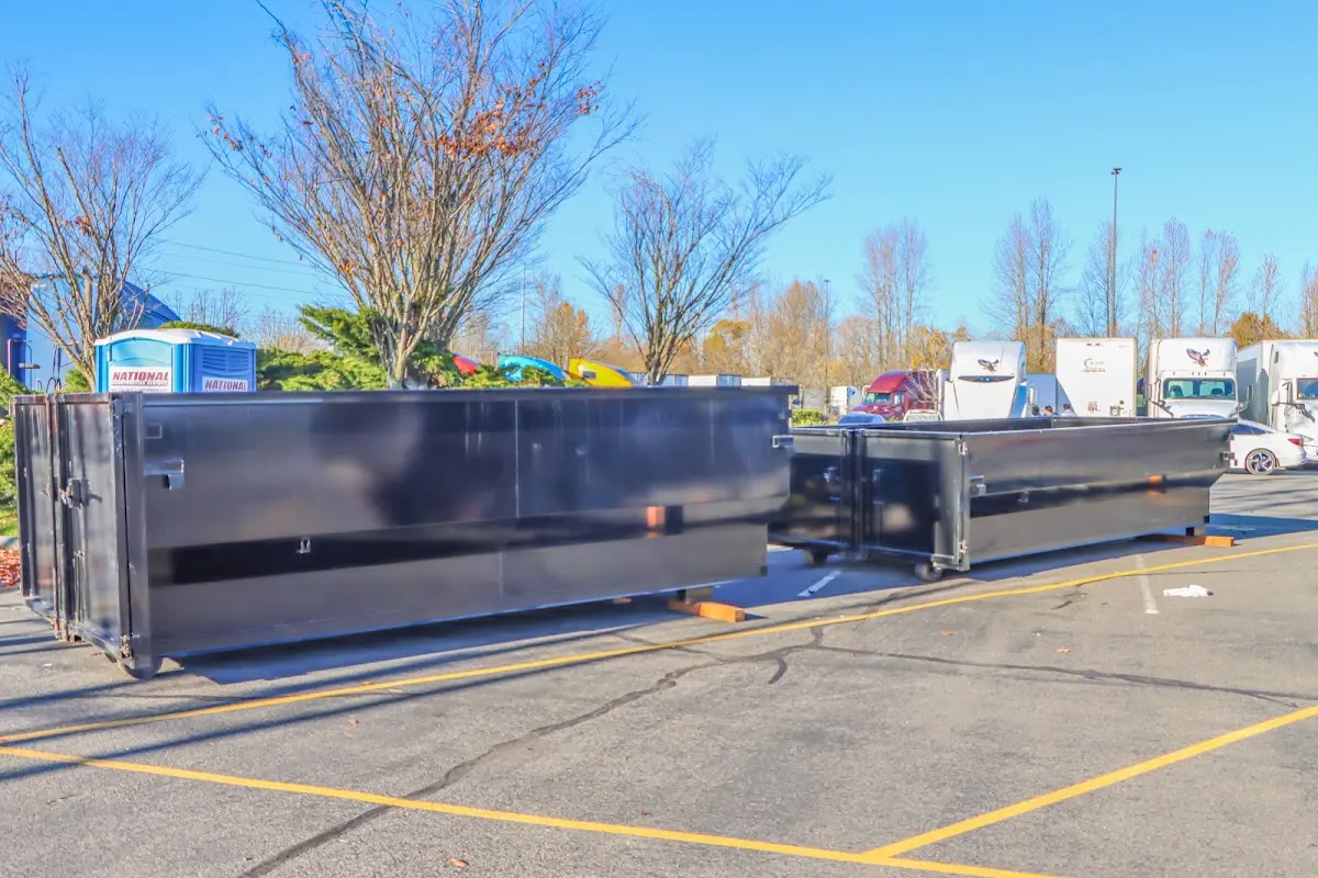 Professional dumpster rental service with roll-off container on residential driveway in Harrisonburg